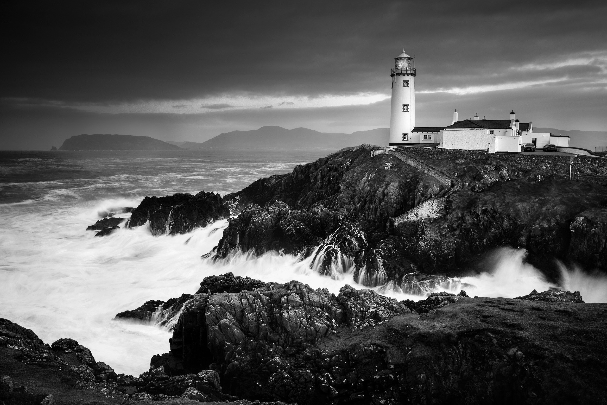 Fanad Head — monochrome lighthouse above a dramatic Atlantic coastline