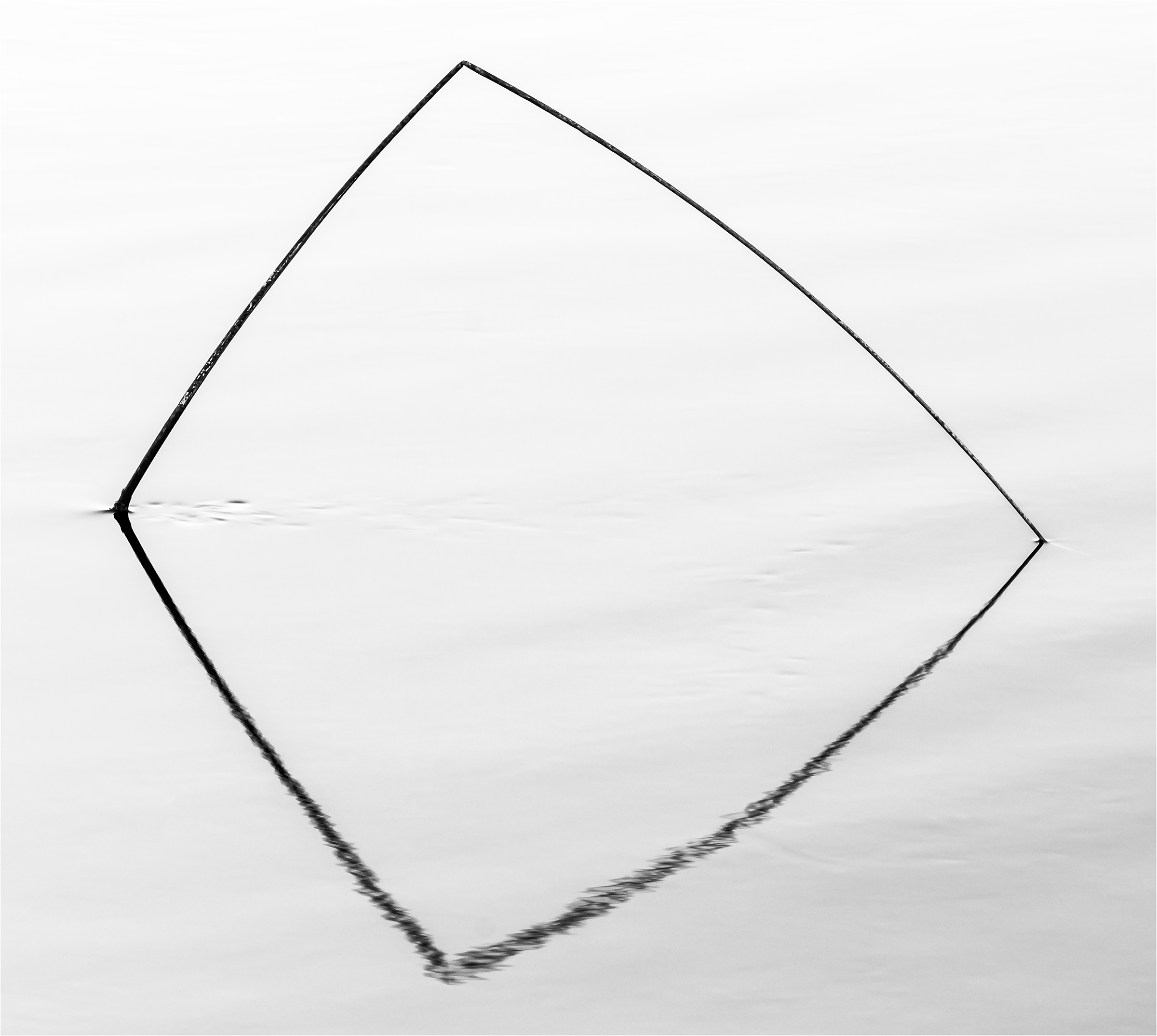Solitaire — a solitary stick and its reflection forming a minimal geometric shape